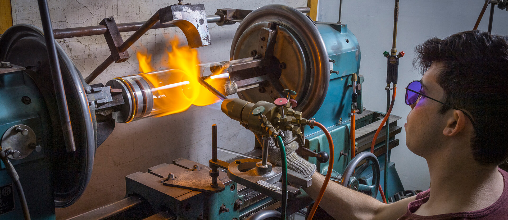 An Astraglass Innovations worker creates a new piece of scientific glassware on industrial machinery